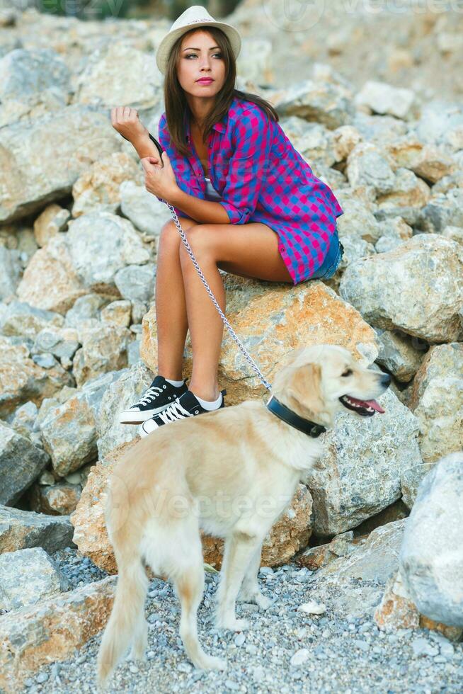 Woman with a dog on a walk on the beach photo