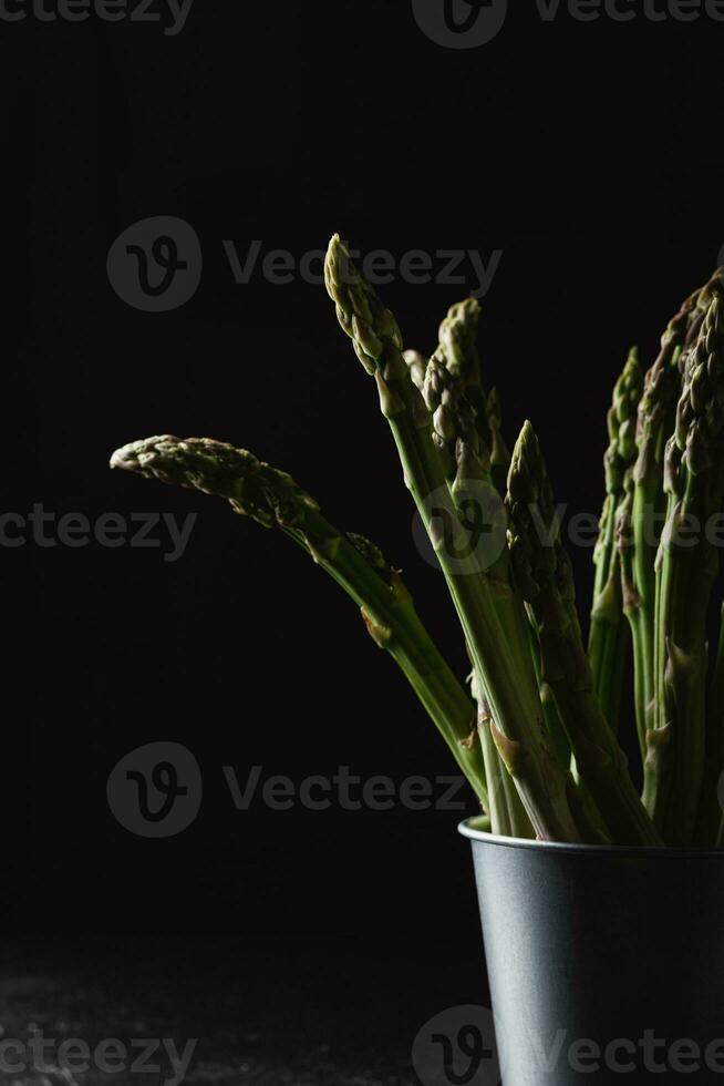 Green asparagus on a black background photo