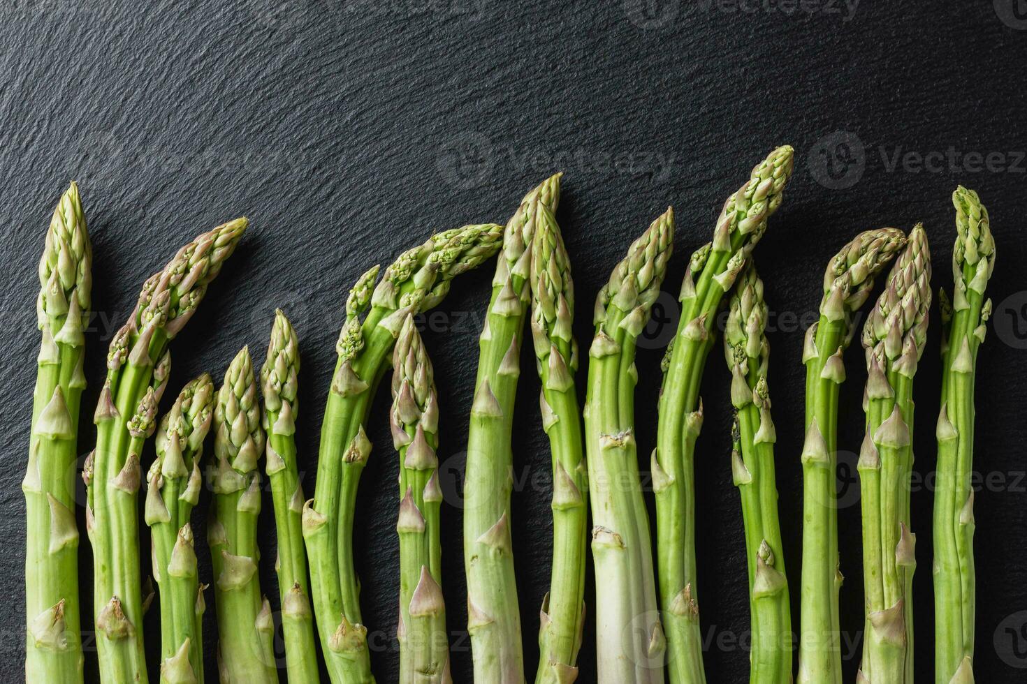 Green asparagus on a black background photo