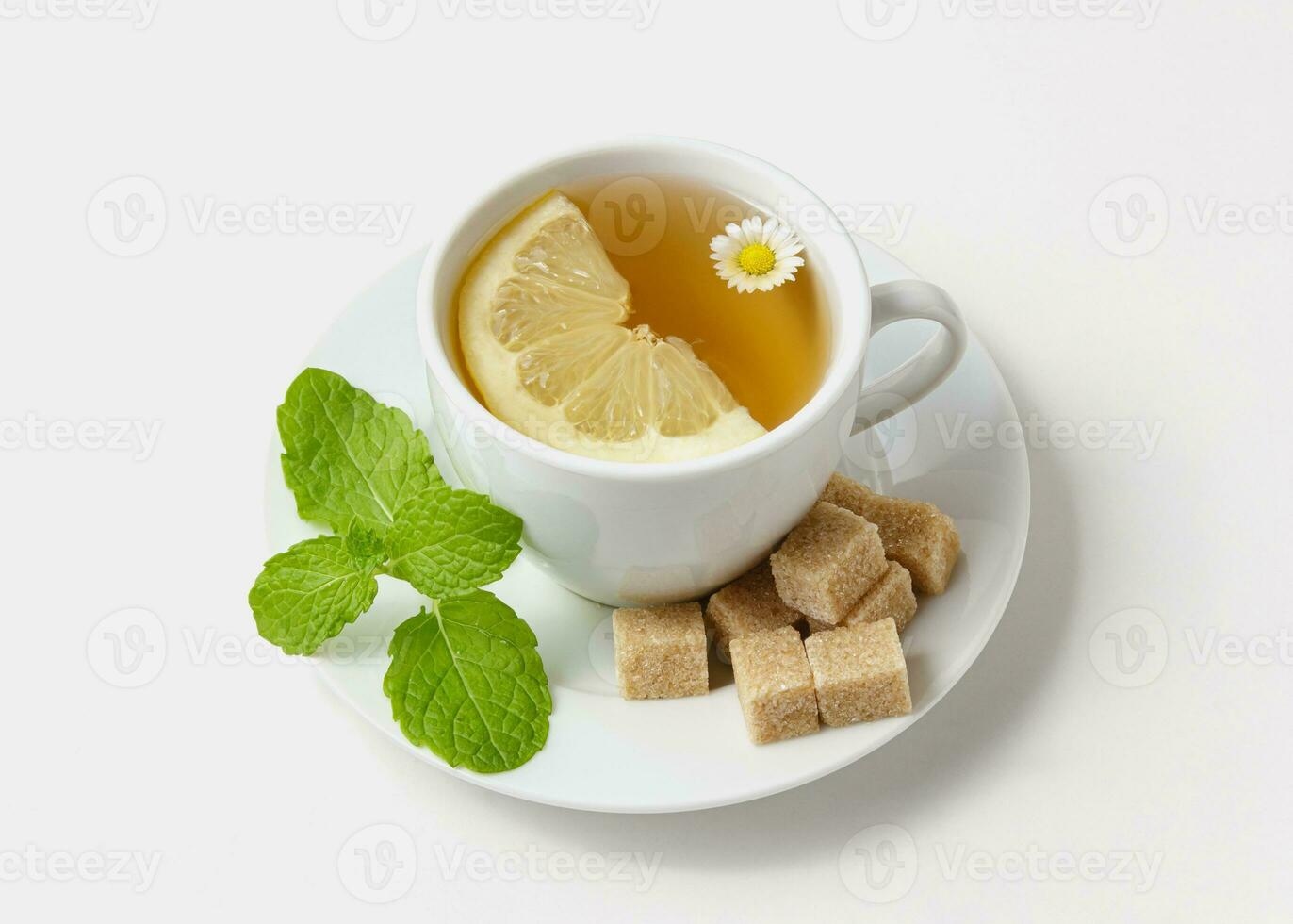 Chamomile tea with mint and lemon on white background. photo