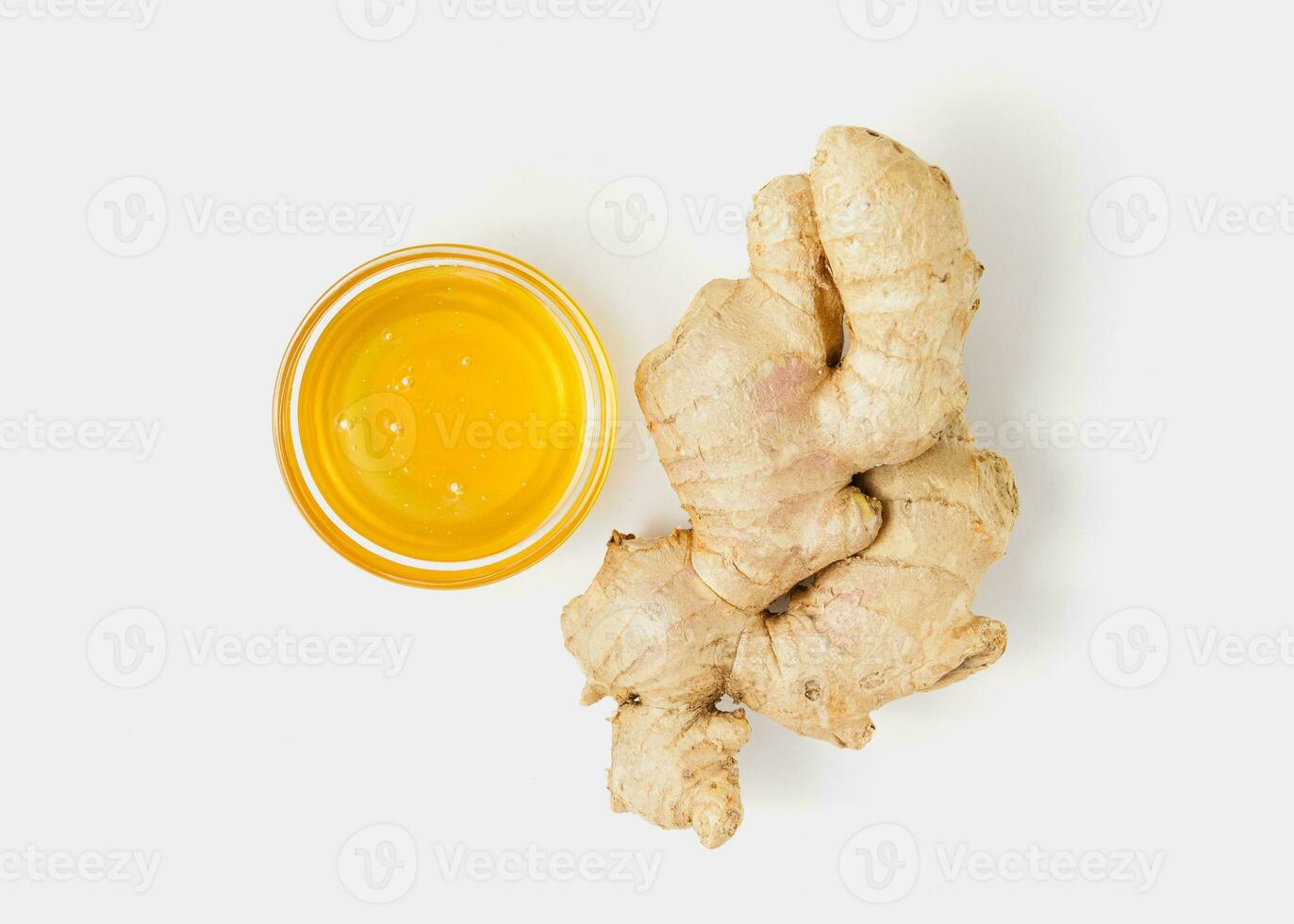 Ginger with honey in bowl on white background. photo