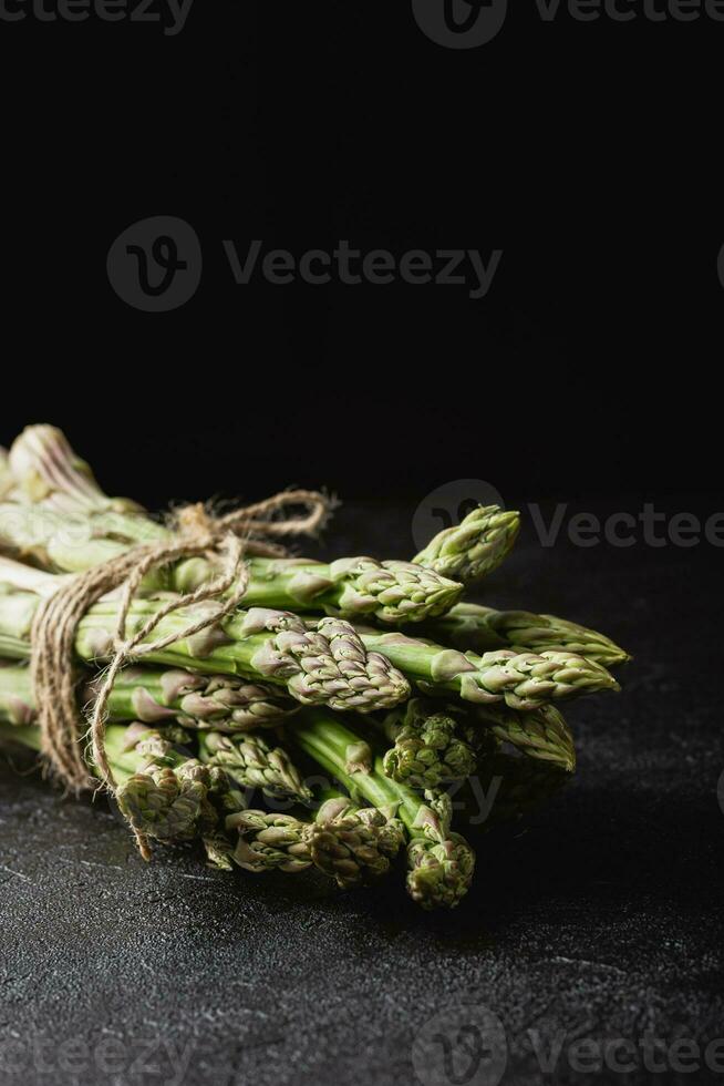 Green asparagus on a black background photo