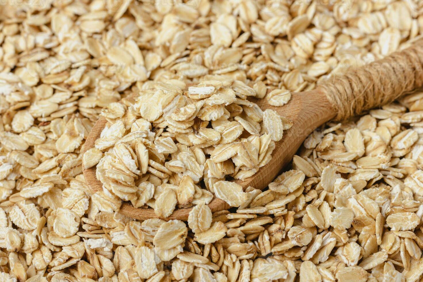 Oat flakes with wooden spoon. photo