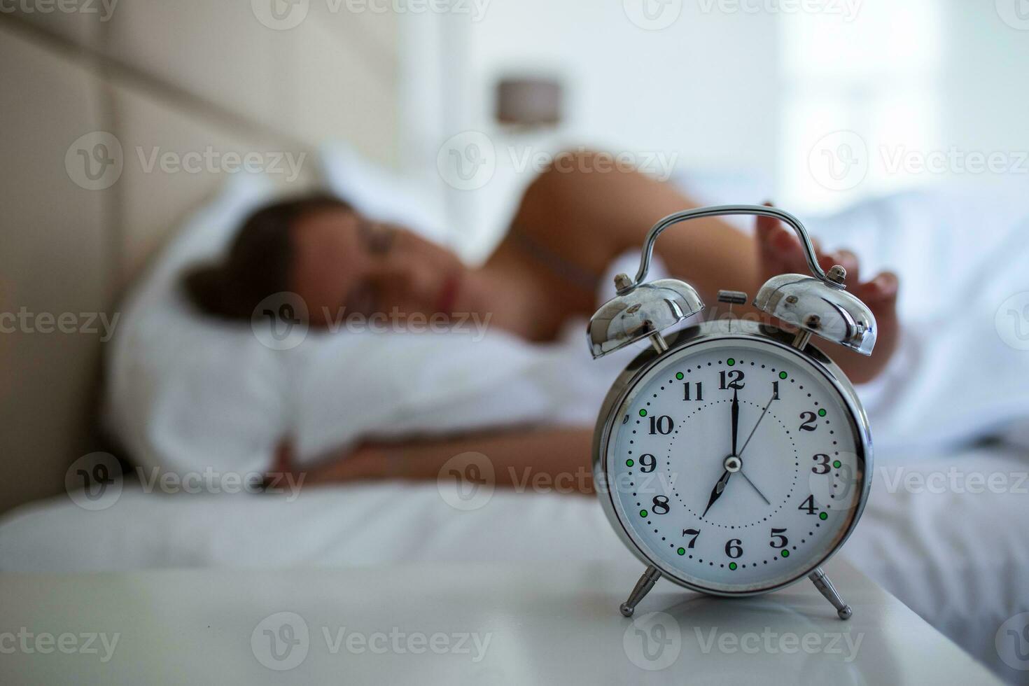 Woman with insomnia lying in bed with open eyes. Girl in bed suffering insomnia and sleep disorder thinking about his problem at night photo