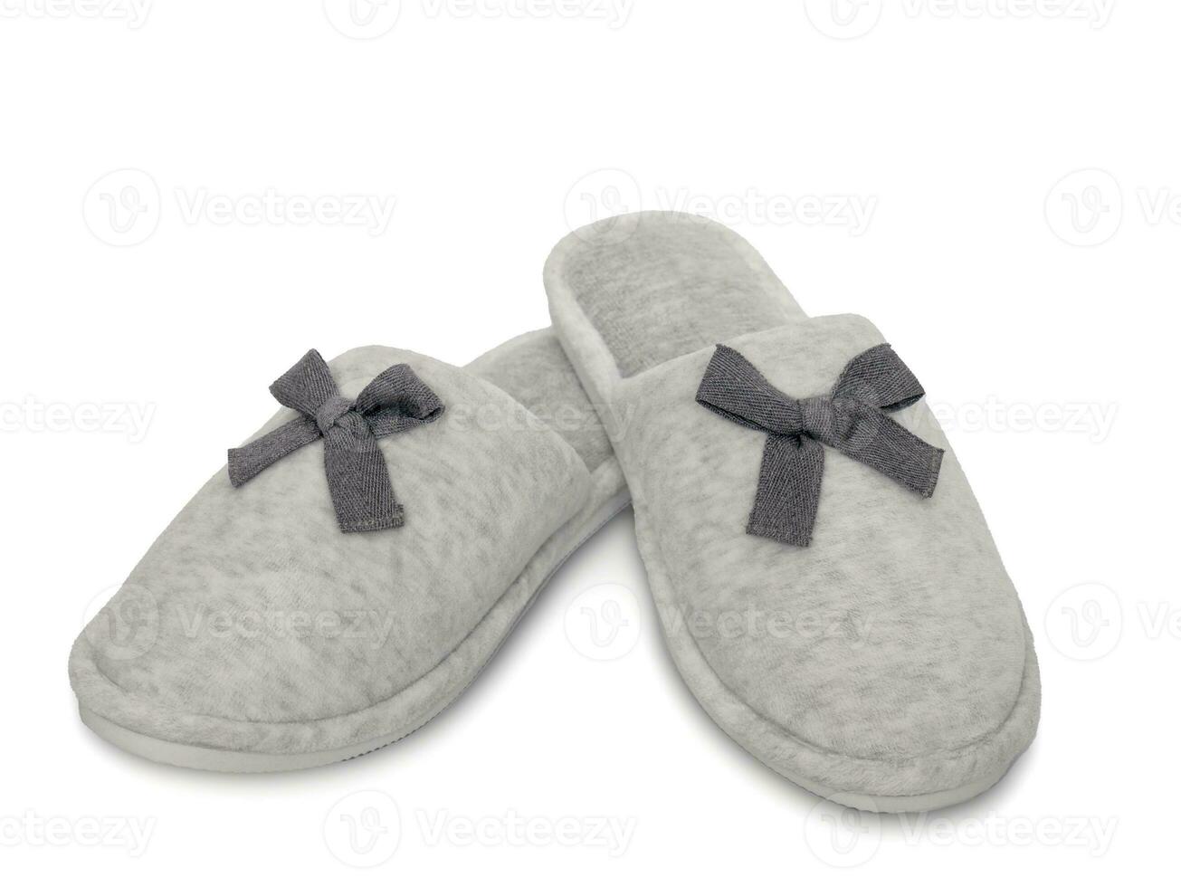 Soft cozy women's home slippers isolated on a white background. Comfortable home shoes. Hotel bath slippers photo