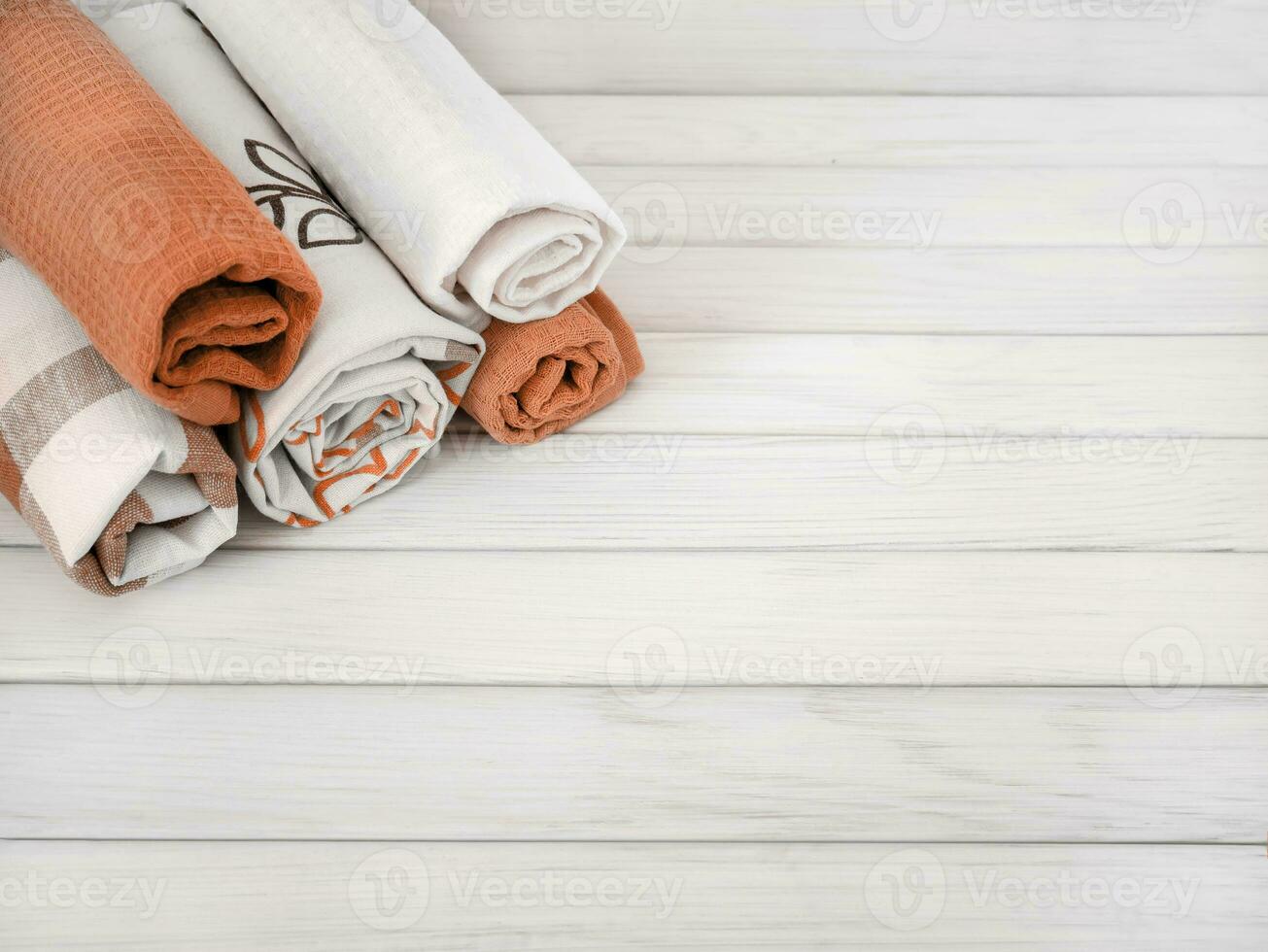 A pile of neatly folded towels on wooden background. Production of