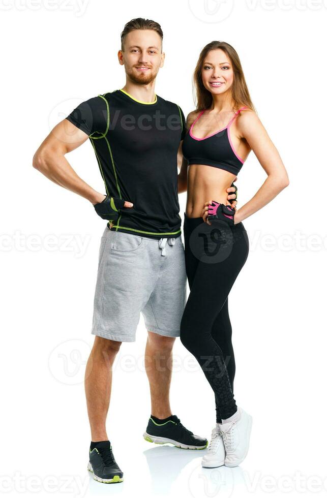 Athletic couple - man and woman after fitness exercise on the white photo