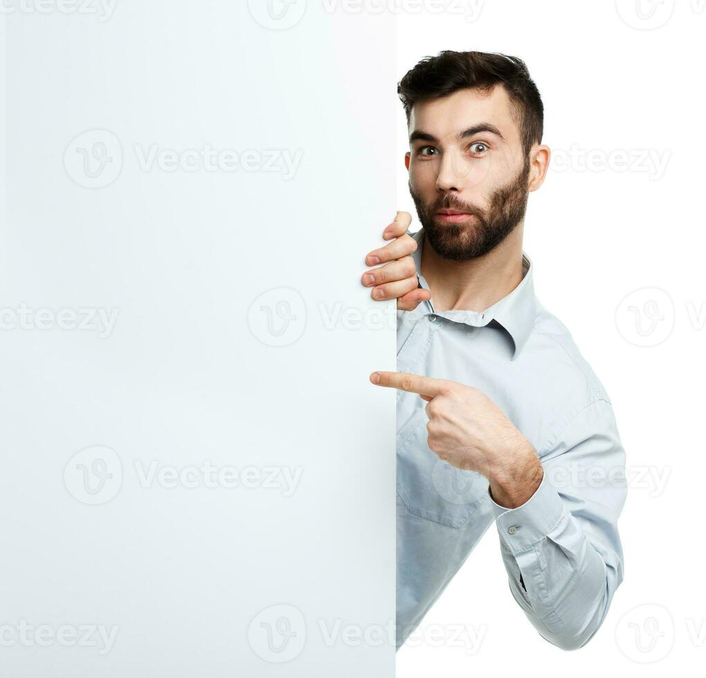 A young bearded man showing blank signboard, isolated over white photo