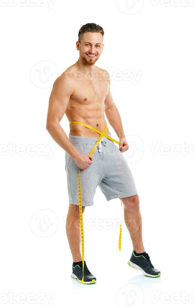 Athletic man with measuring tape on the white photo
