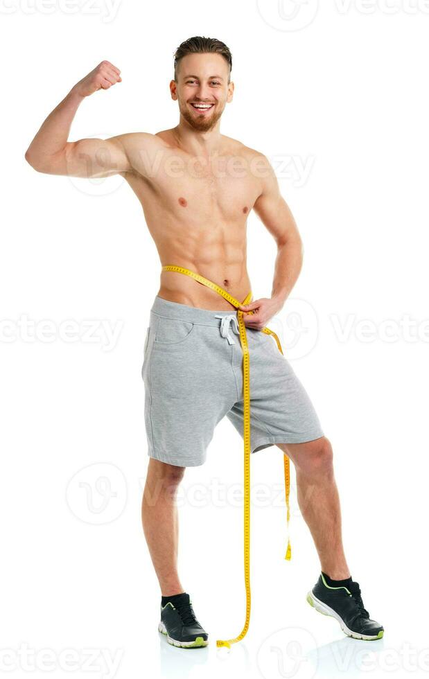 Athletic man with measuring tape on the white photo