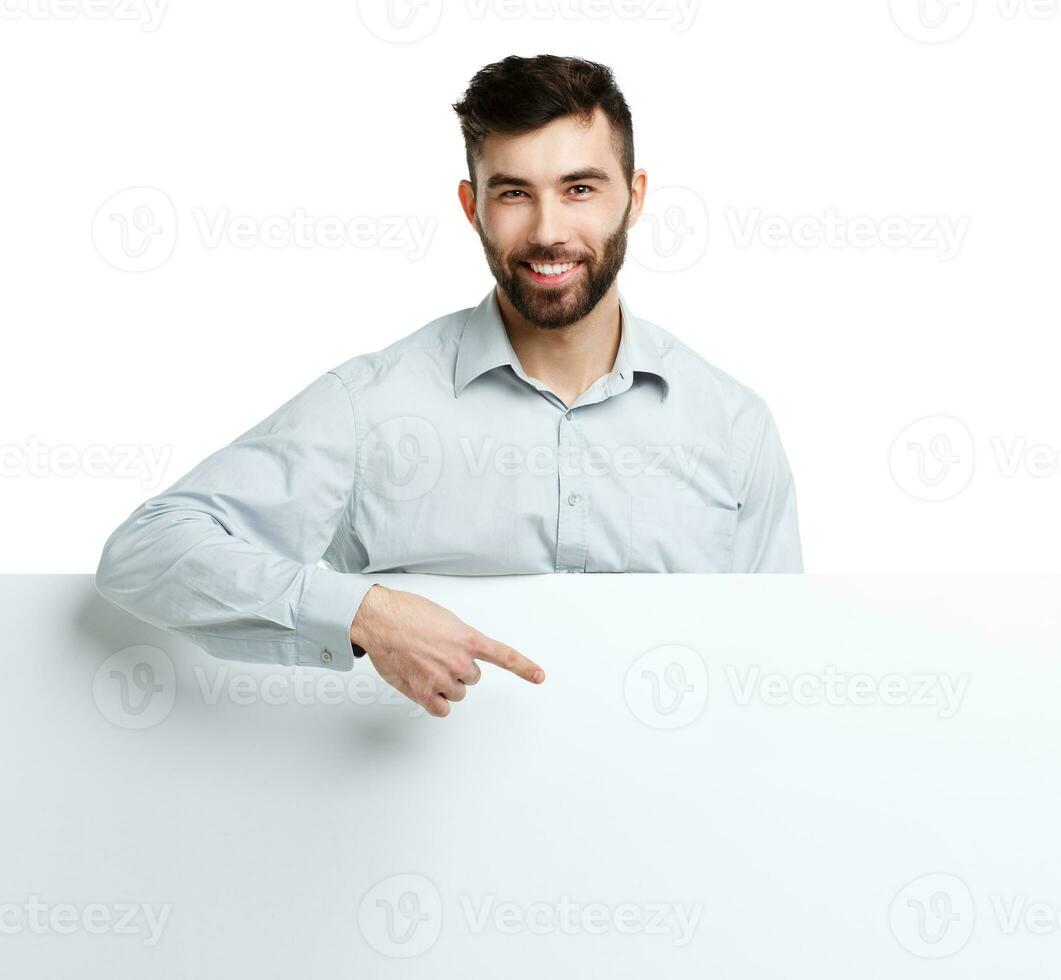 A young bearded man showing blank signboard, isolated over white photo