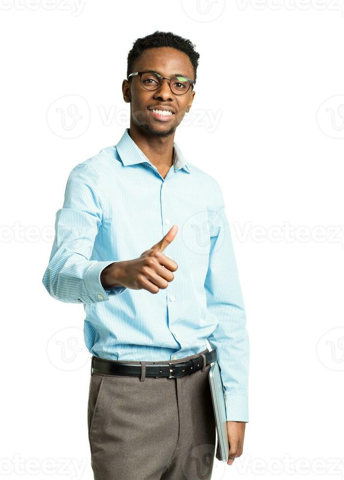 Happy african american college student with laptop and finger up  standing on white photo