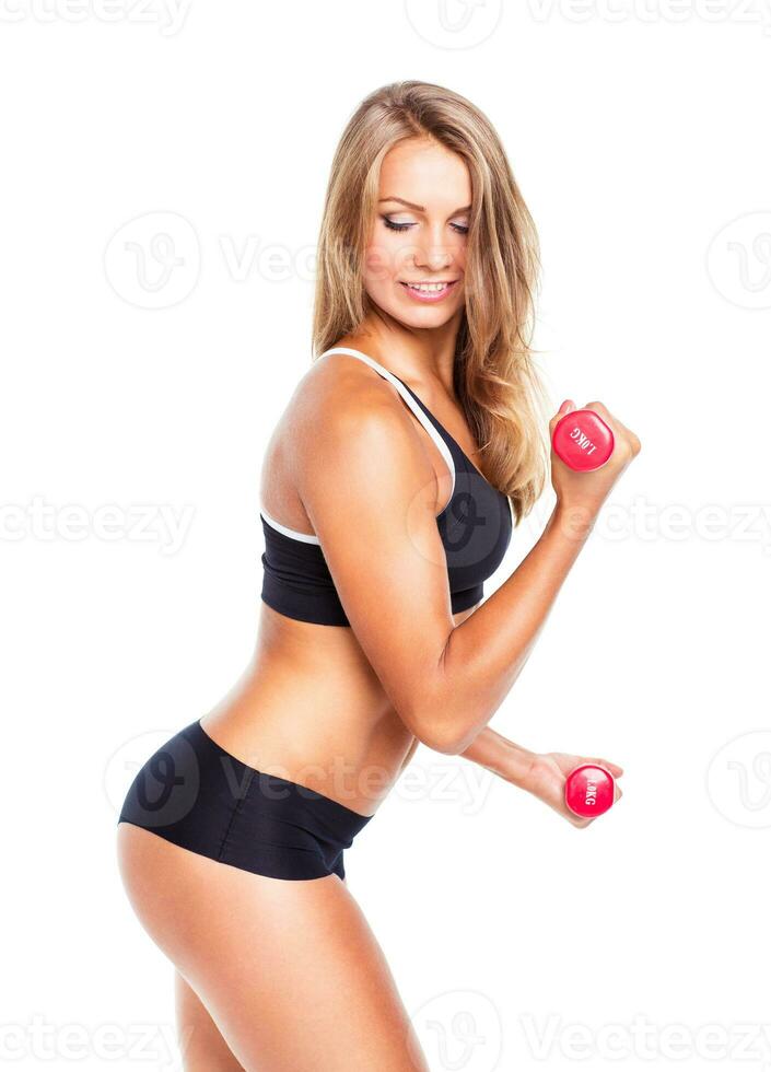 Beautiful slim woman with dumbbells, isolated on white photo