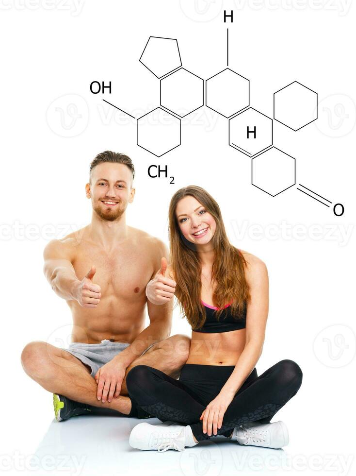 Athletic man and woman after fitness exercise with a finger up on the white with the chemical formula on background photo