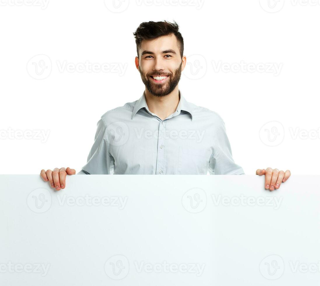 A young bearded man showing blank signboard, isolated over white photo