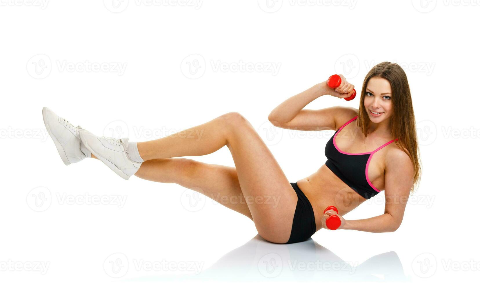 Happy athletic woman with dumbbells doing sport exercise, isolated on white photo