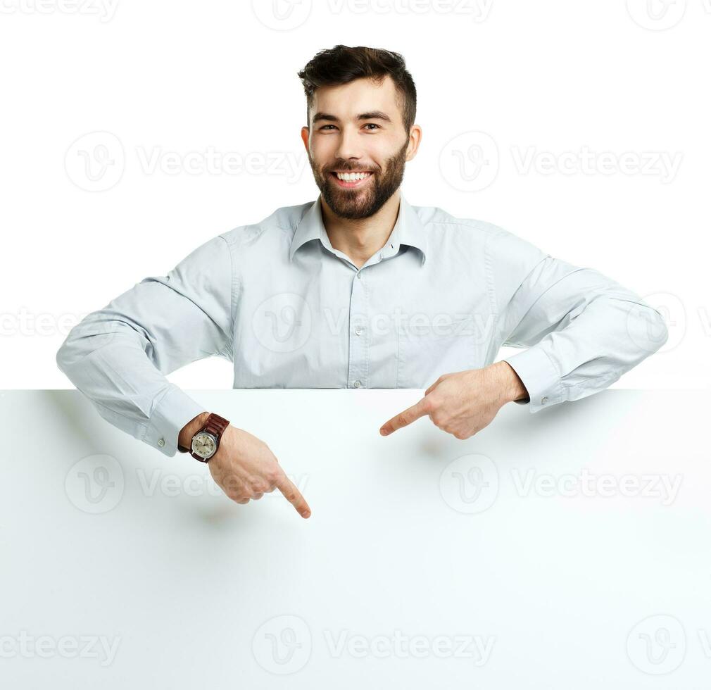 A young bearded man showing blank signboard, isolated over white photo