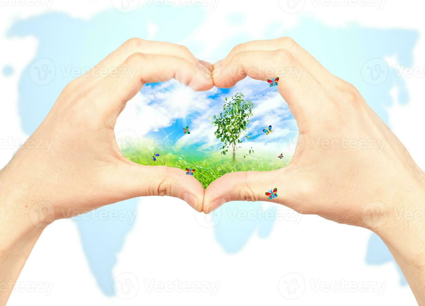 Human hand and nature on world map background. photo