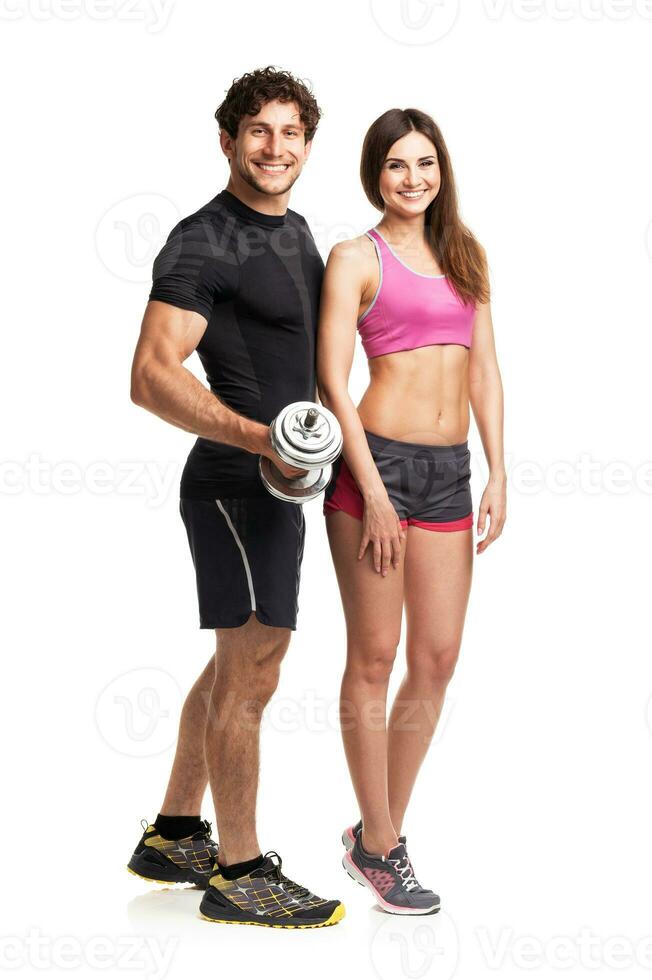 Sport couple - man and woman with dumbbells on the white photo