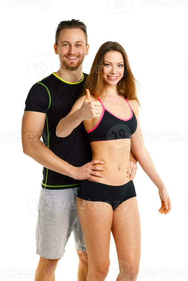 Athletic man and woman after fitness exercise with a finger up on the white photo