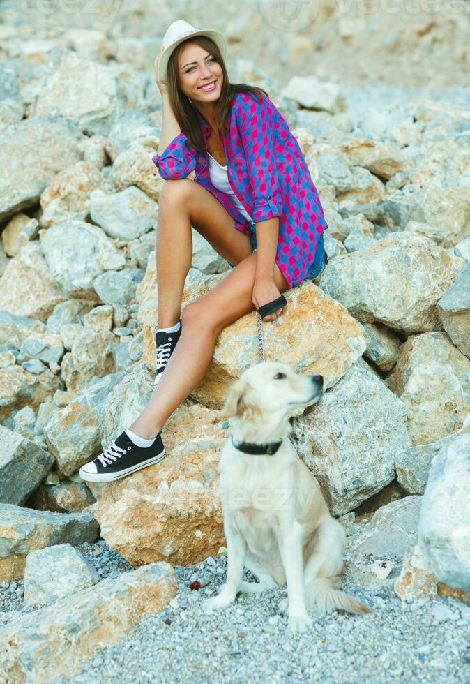 Woman with a dog on a walk on the beach photo