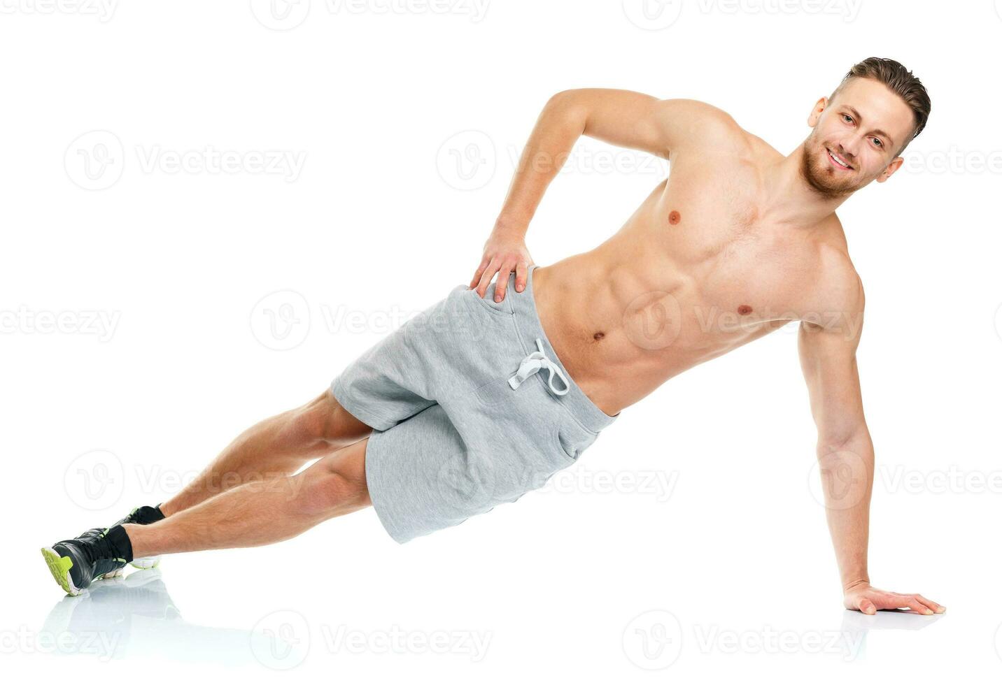 Sport attractive man doing fitness exercises on the white photo