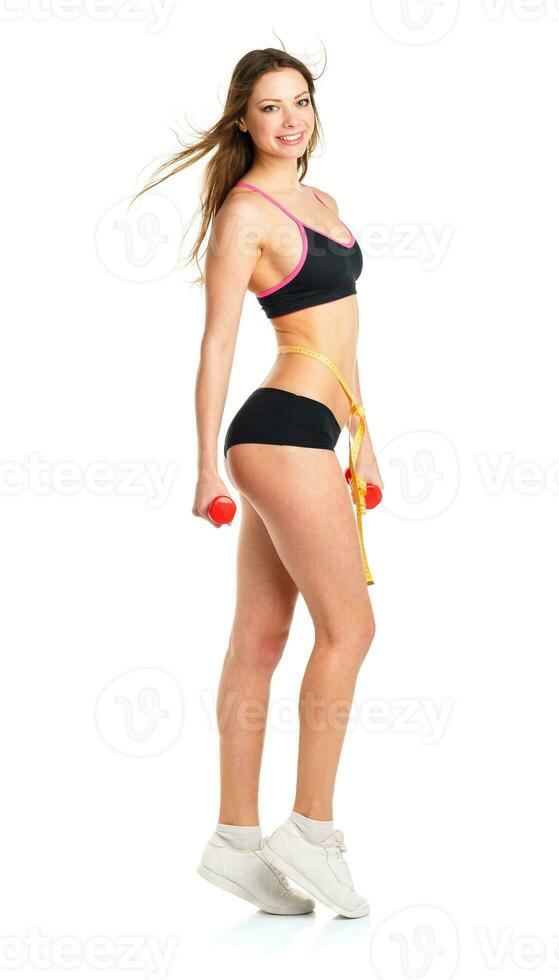 Happy athletic woman with dumbbells doing sport exercise photo
