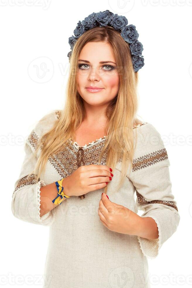 Young beautiful smiling girl in Ukrainian costume on the white photo