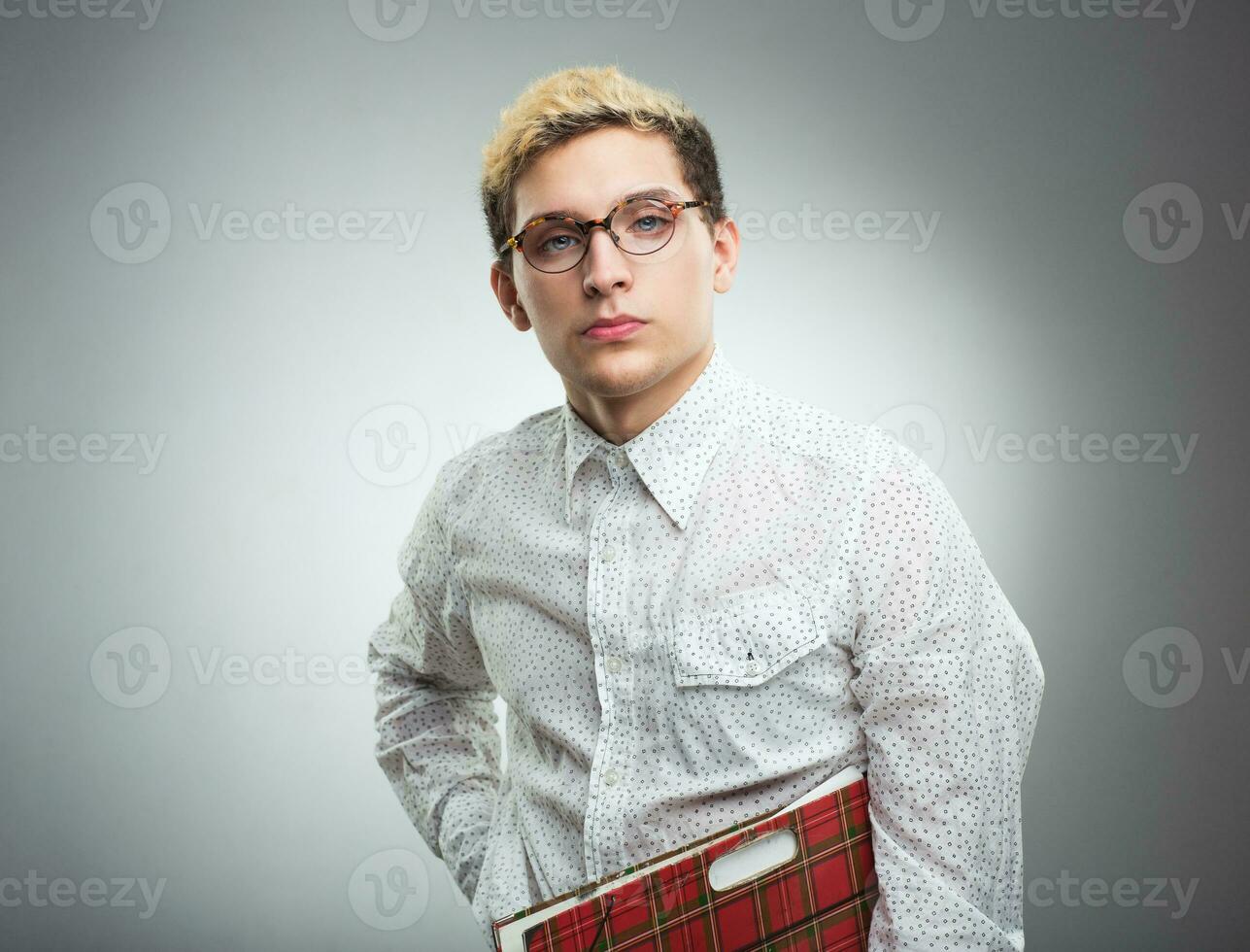 Young serious man looking to the camera wearing glasses photo