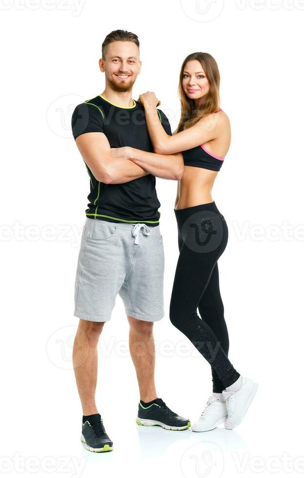 Athletic couple - man and woman after fitness exercise on the white photo