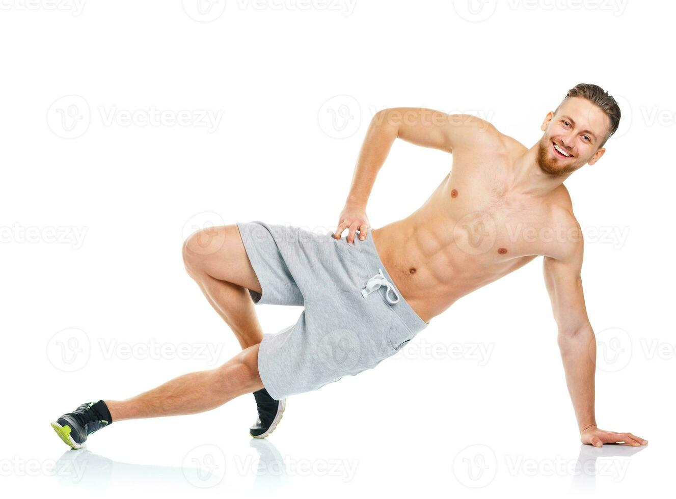 Sport attractive man doing fitness exercises on the white photo