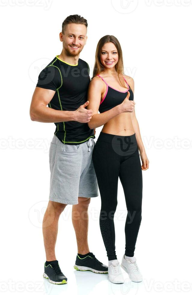 Sport man and woman after fitness exercise with a finger up on the white photo