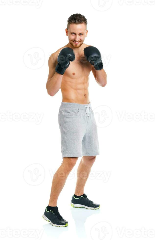 Athletic attractive man wearing boxing gloves on the white photo