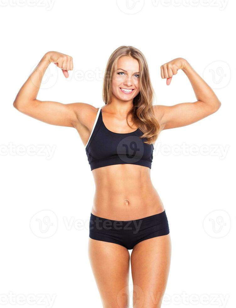 Young sports girl does exercises on a white photo