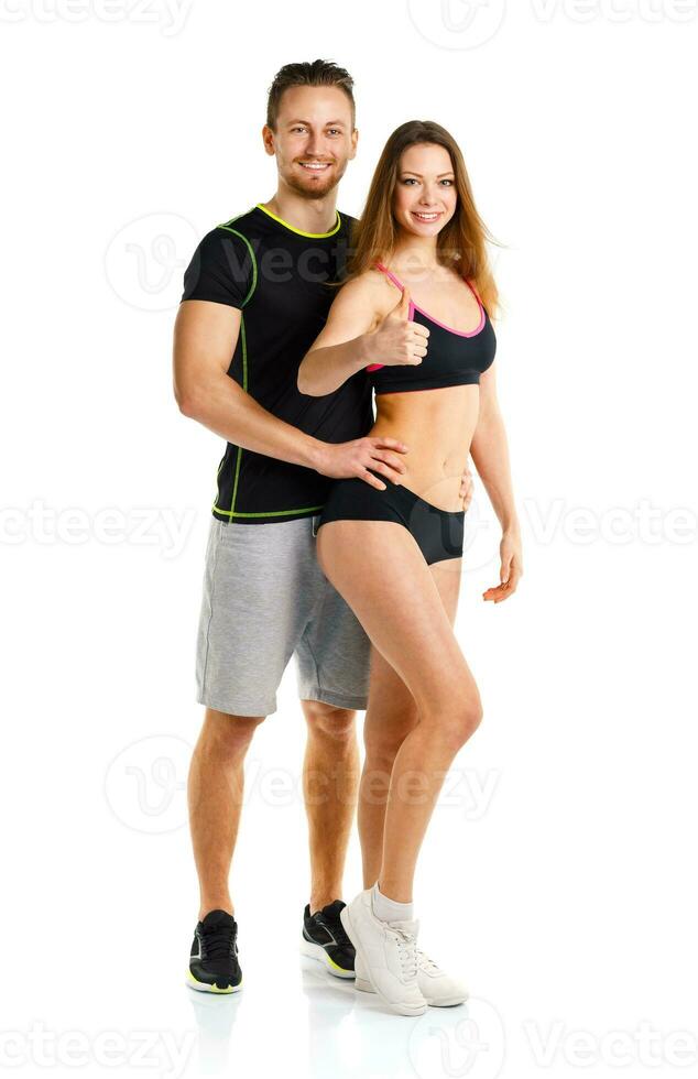 Athletic man and woman after fitness exercise with a finger up on the white photo