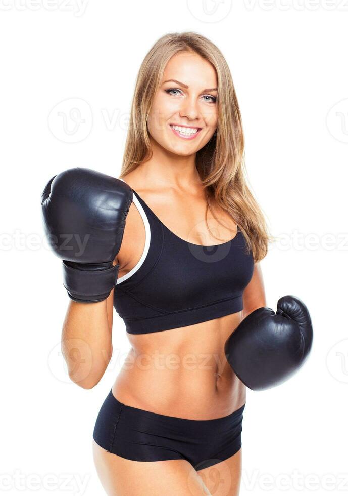 Young athletic woman in boxing gloves on a white photo
