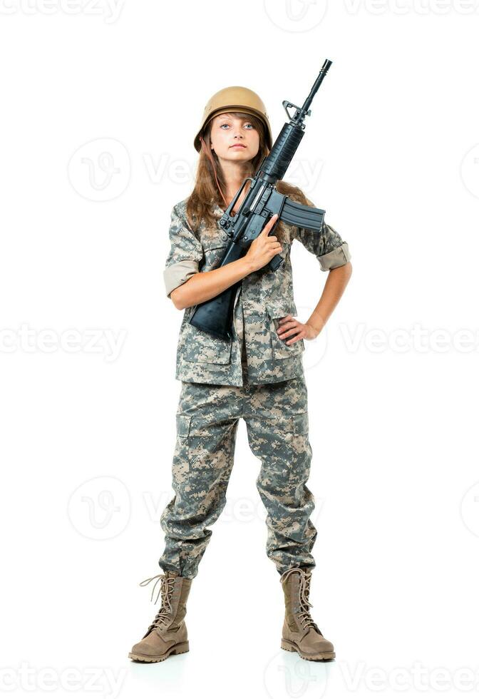 Soldier young beautiful girl dressed in a camouflage with a gun in his hand on white photo