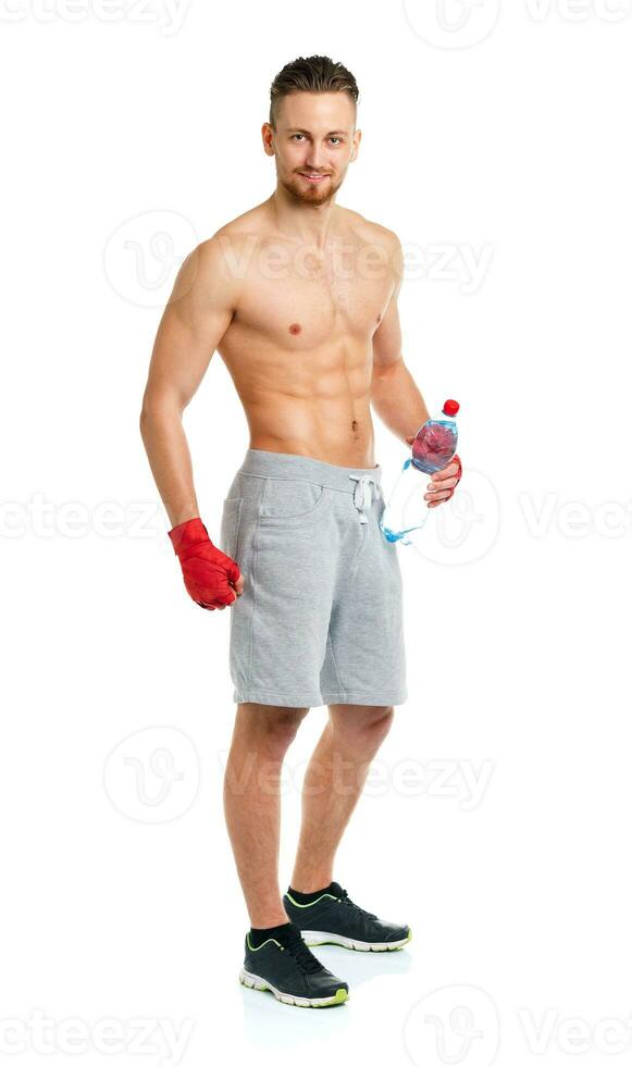 Sport attractive man wearing boxing bandages and drinking fresh water on the white photo