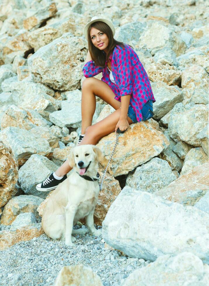 Woman with a dog on a walk on the beach photo