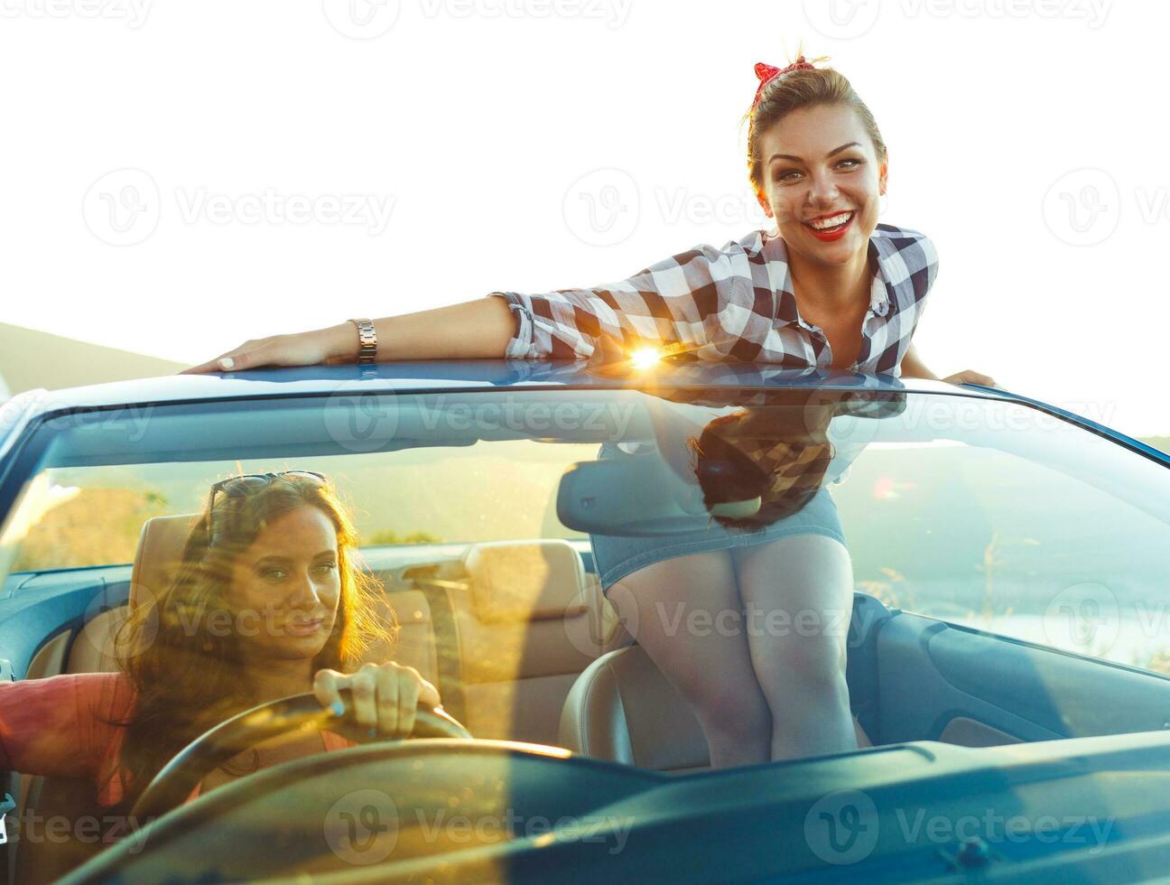 dos joven muchachas conducción un cabriolé foto
