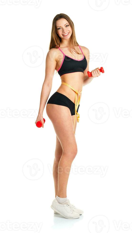 Happy athletic woman with dumbbells doing sport exercise photo