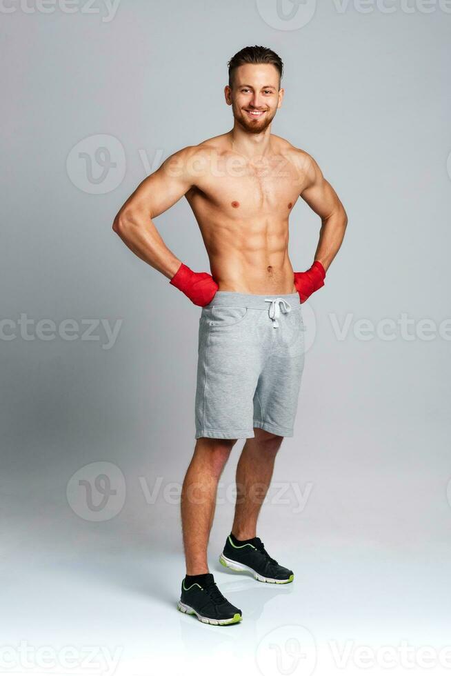 Athletic man wearing boxing bandages photo