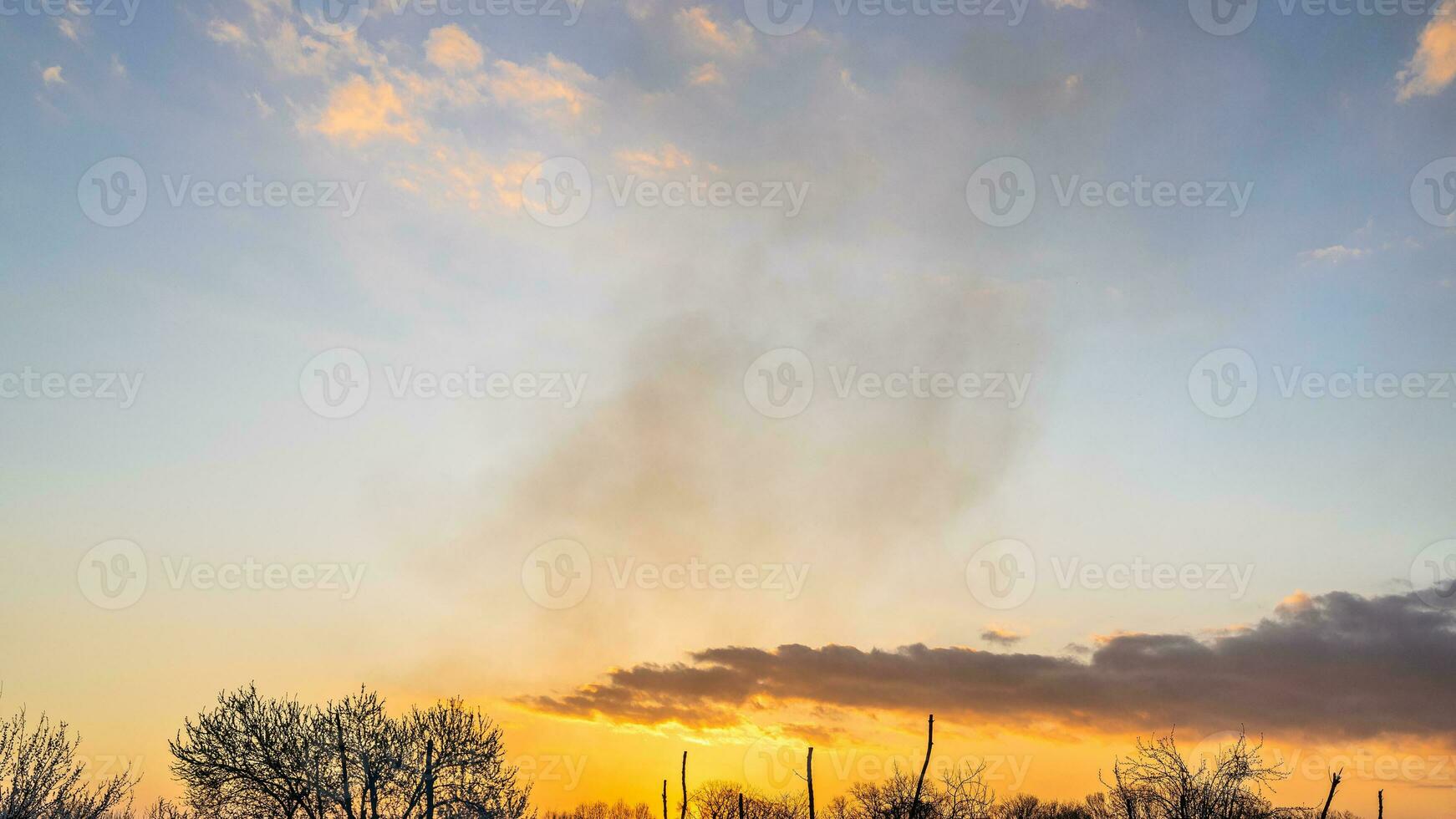 panoramic view of sunset sky with smoke in spring photo