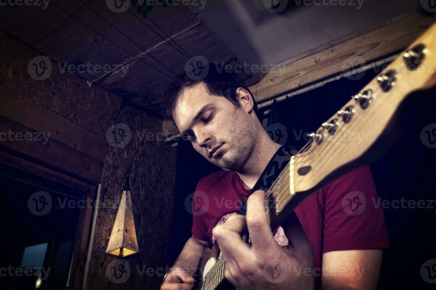 Guitar playing by man photo