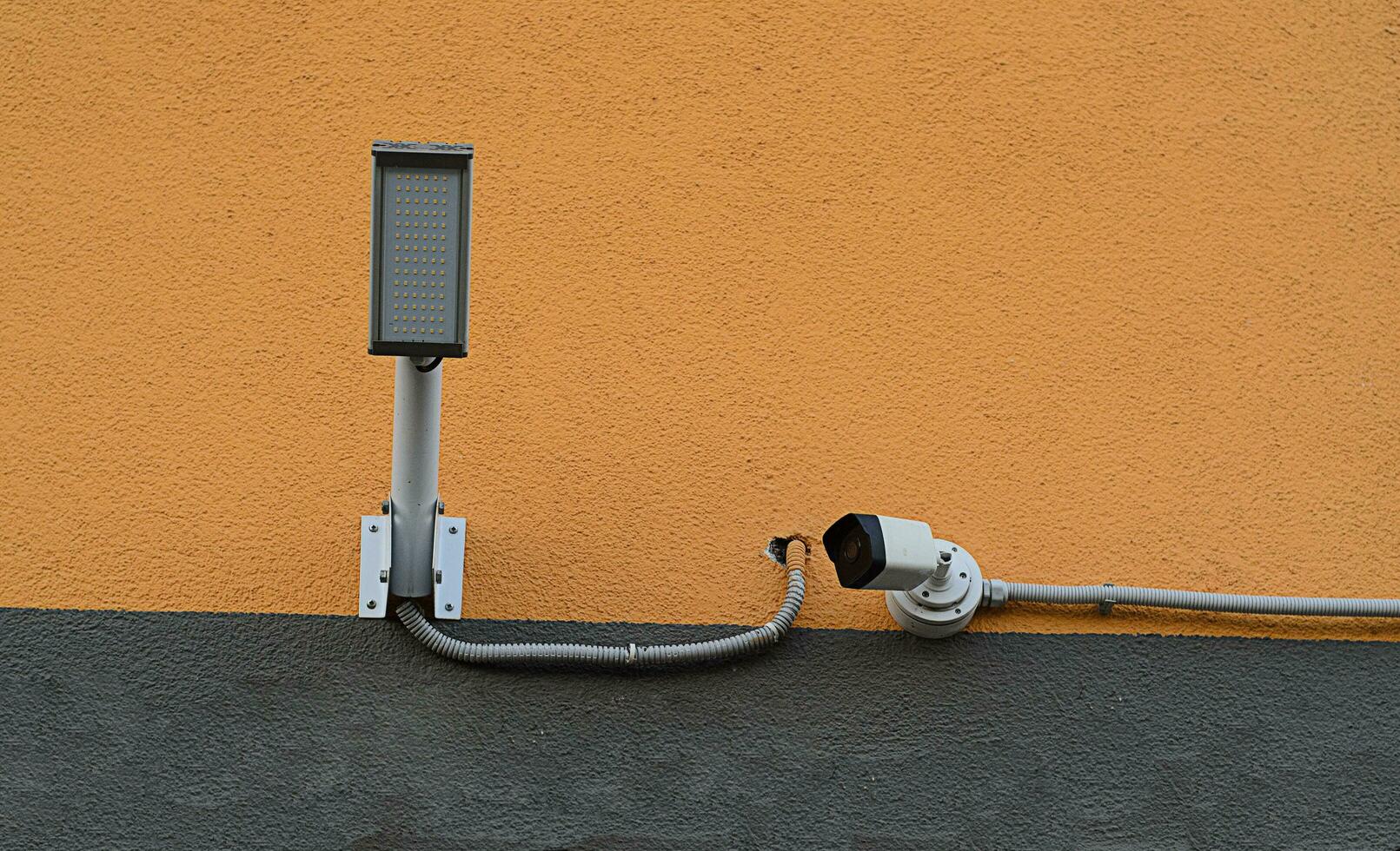 camera for security with lamp on house wall photo