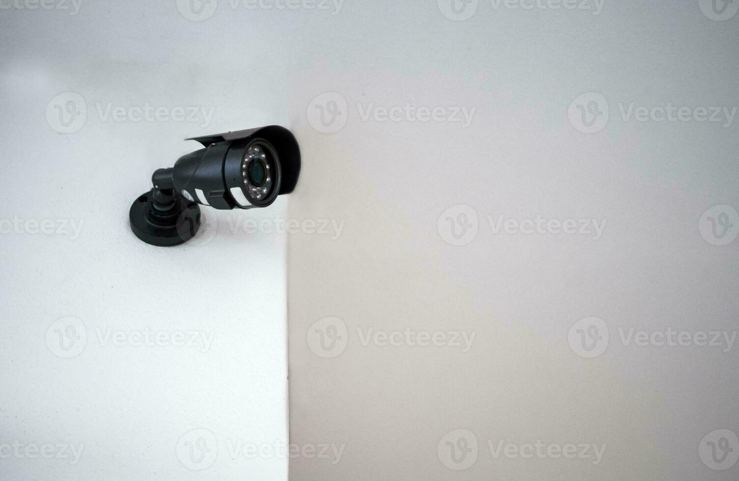 CCTV cameras installed on a white wall. Concept of surveillance and monitoring. photo