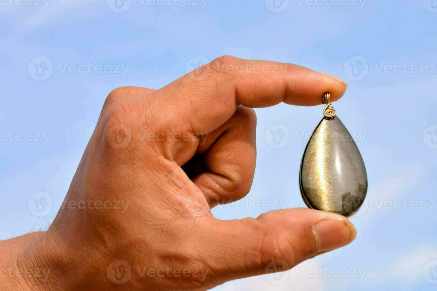 Hand holding a semi precious stone photo