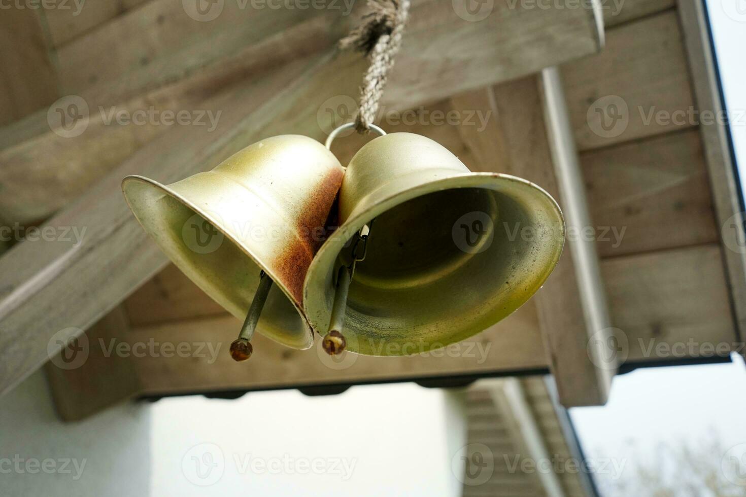 Gold decorative house bells. Golden bells hanging in front of house doors. photo