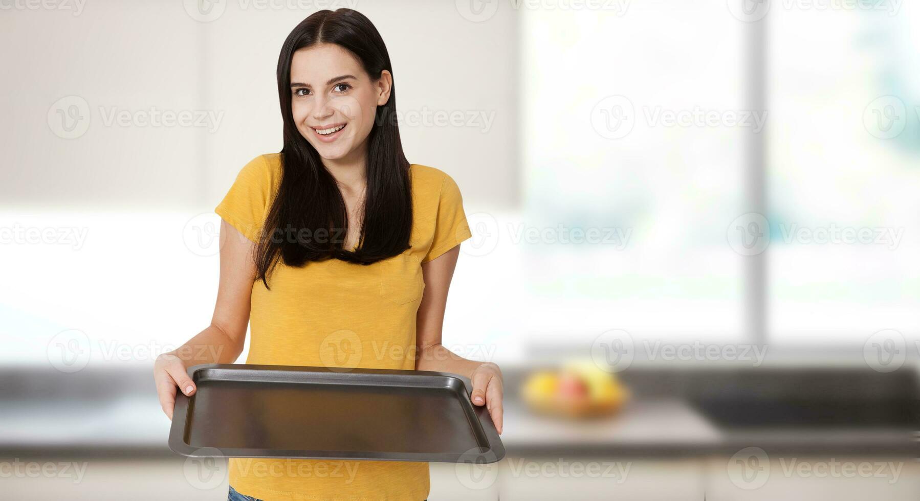 Kitchen woman gives empty tray for your advertising products at home in the kitchen near the window. Mock up for use photo