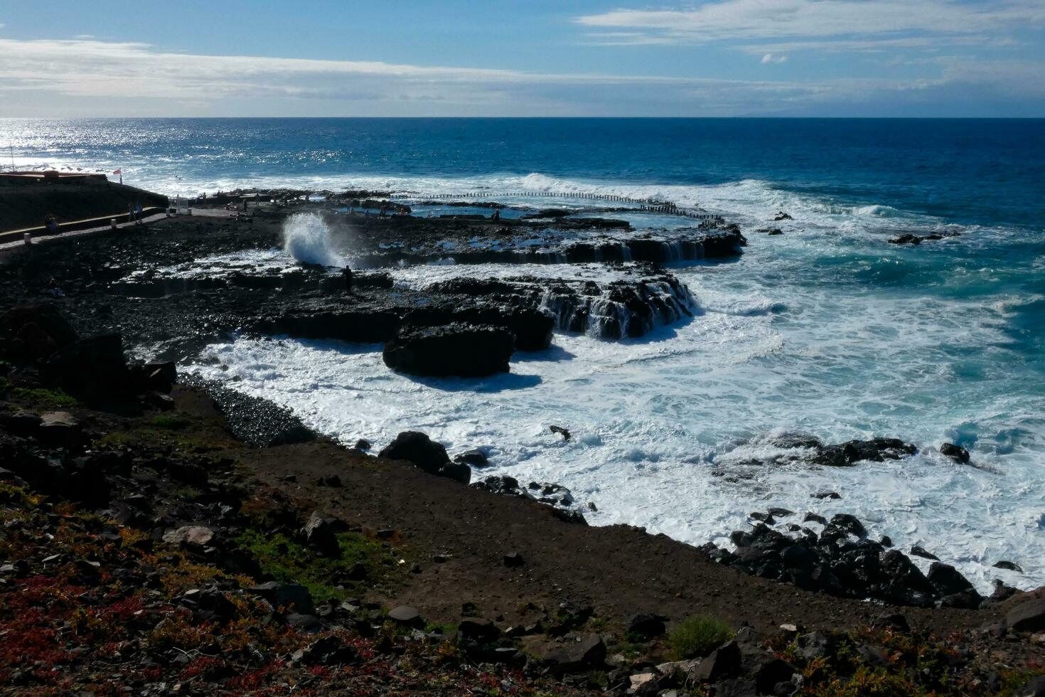 Large waves crashing against the rocks in the ocean photo